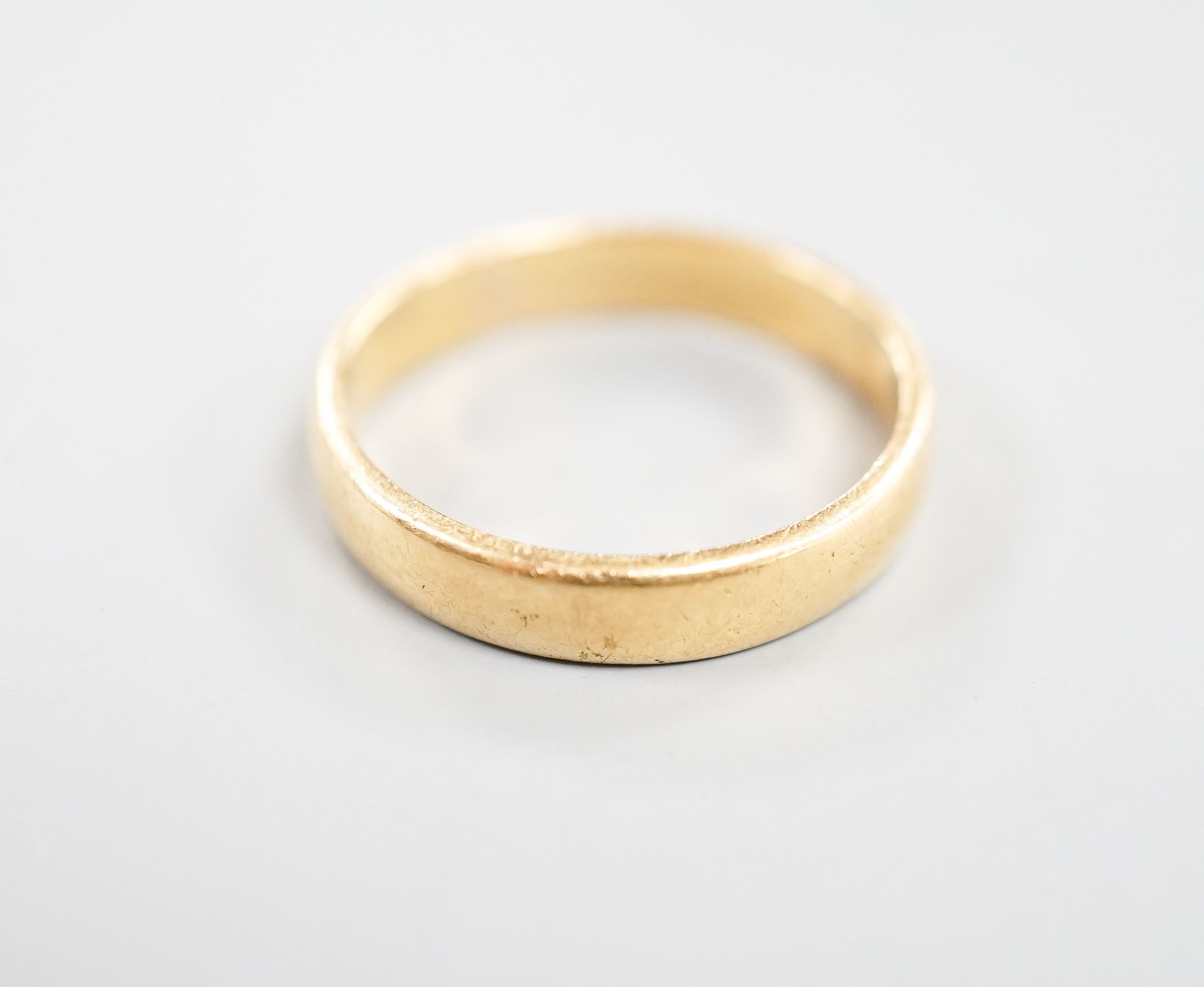 A 22ct wedding band, size N, 4.3 grams.